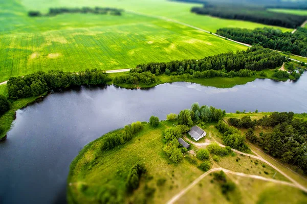 Drone image. A view from above on a natural lake, road and field — Stock Photo, Image