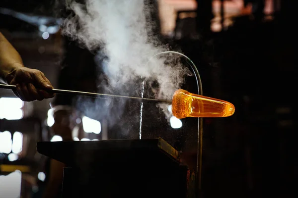 Glass blower forming piece of glass, water cooling. — Stock Photo, Image