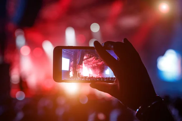Fans taking photo of concert at festival