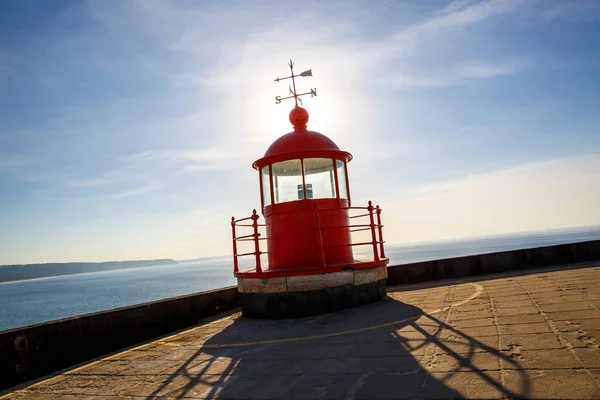 Red lighthouse lamp room on blue sky and sea background — Stock Photo, Image