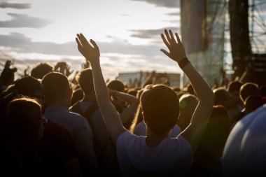 Gençler kendilerini, zevk yaz Müzik Festivali'nde yükseltilmiş eller, gün batımı