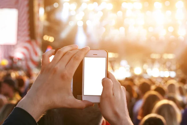 Hands with a smartphone records live music festival, Taking photo of concert stage, live concert on summer outdoor fest