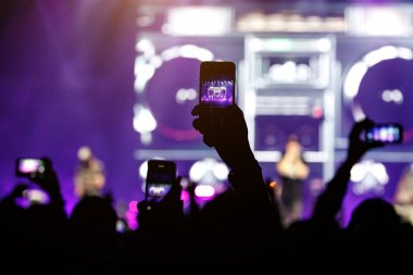 bir el ile bir smartphone bir konserde silüeti