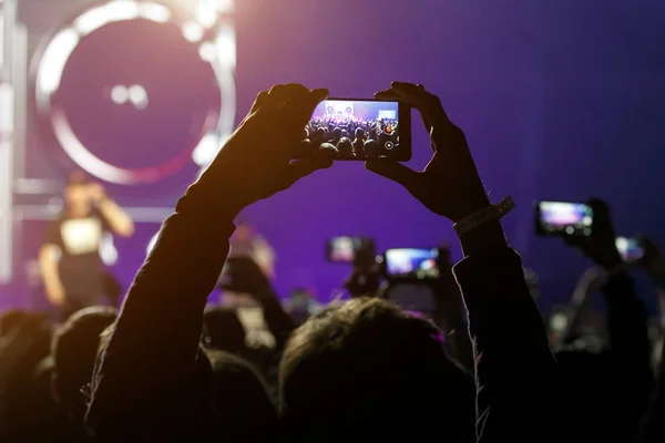 Hand with a smartphone on live music concert, Taking photo of stage, live, music festival