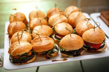 mini burger canape selection on slate platter clipart