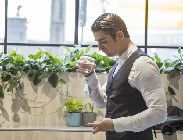 Business men feel sick, have fever, take medicine and drink water while working at the office