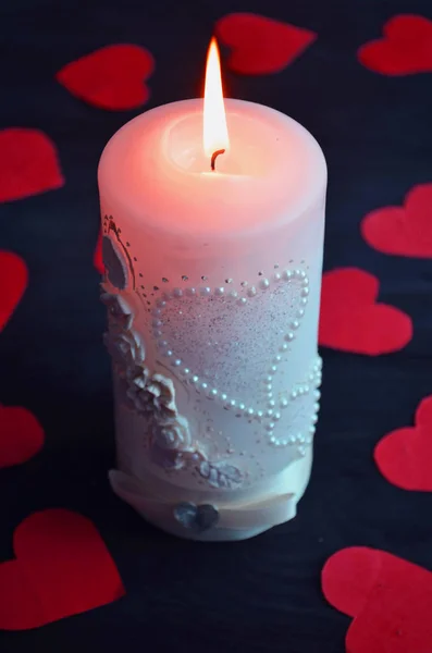 Burning candle, romantic atmosphere. On a wooden board. Valentine's Day. Valentine Stock Picture