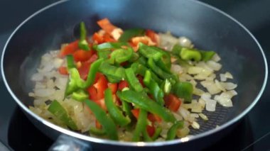 fry peppers and onions in a skillet with butter