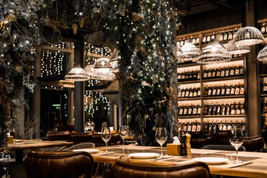 wine restaurant. scenery for the new year. bottles of wine, tangerines, christmas tree