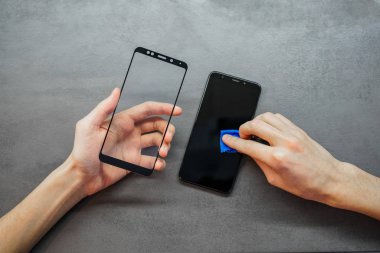 replacement of broken glass with a new one. Broken smartphone display. Broken glass phone. Smartphone Repair
