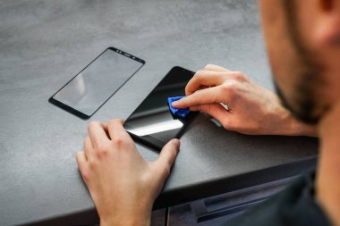 replacement of broken glass with a new one. Broken smartphone display. Broken glass phone. Smartphone Repair