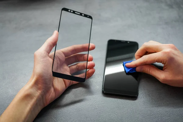 replacement of broken glass with a new one. Broken smartphone display. Broken glass phone. Smartphone Repair