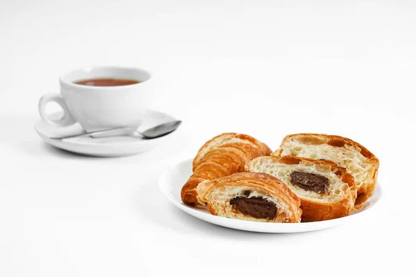 morning tea party. English Afternoon Tea. tea with croissants. light snack between meals. croissant with chocolate on a white background