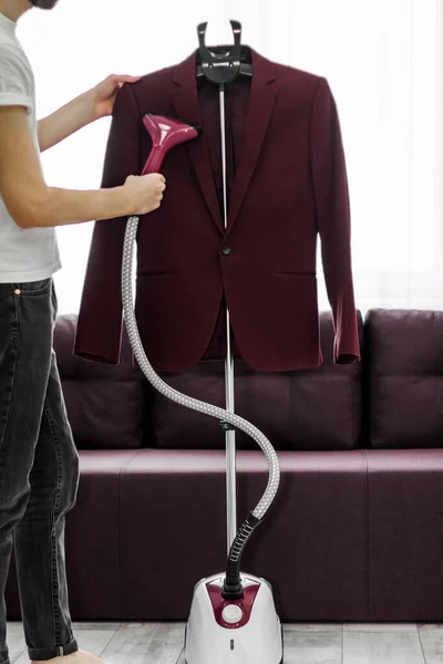 Man Puts Things Order Holds Garment Steamer His Hand Smoothes — Stock Photo, Image