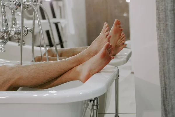 man takes a bath with foam. spa treatments. rest after a hard day. Vintage bath