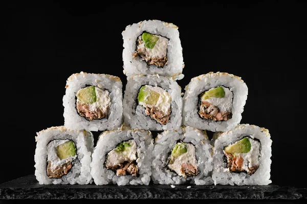 Set of rolls with tuna and cream cheese on a black background. japanese food close-up. veggie dish