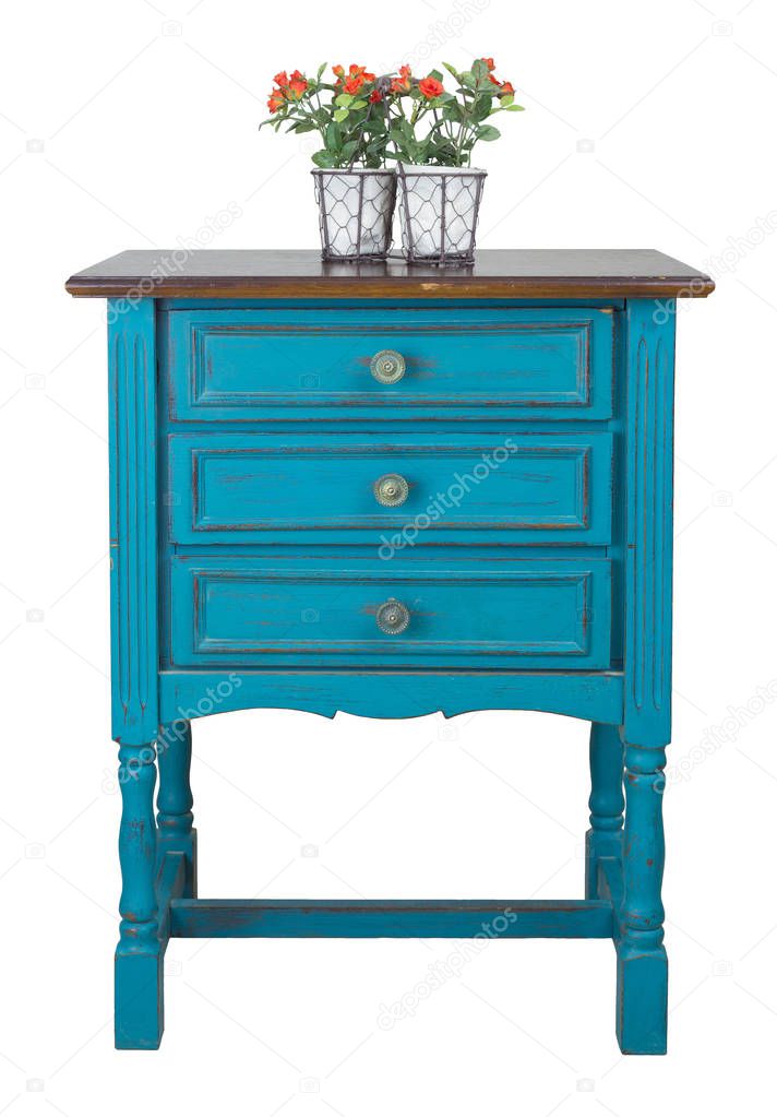 Vintage turquoise commode (Chest of Drawers) with 3 drawers with brass fittings and flower planter isolated on white background including clipping path