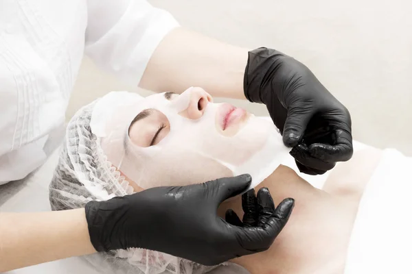 The procedure is a cleansing restorative wet mask for men in a beauty salon.