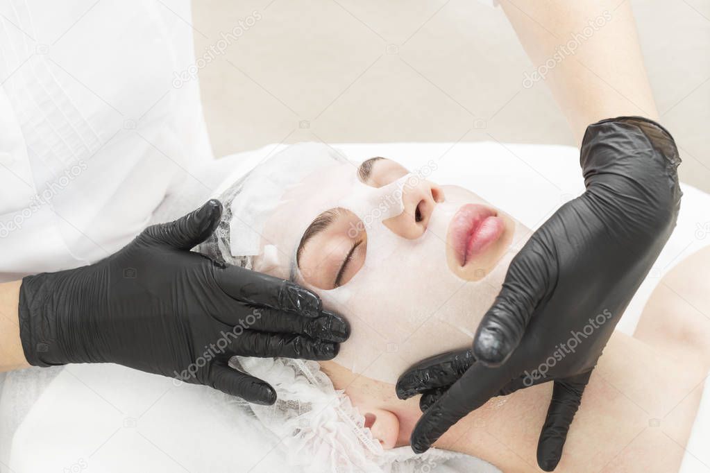 The procedure is a cleansing restorative wet mask for men in a beauty salon.