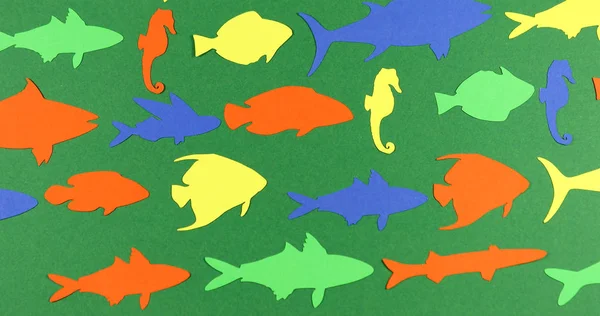 Animated stop motion floating paper colored fish.