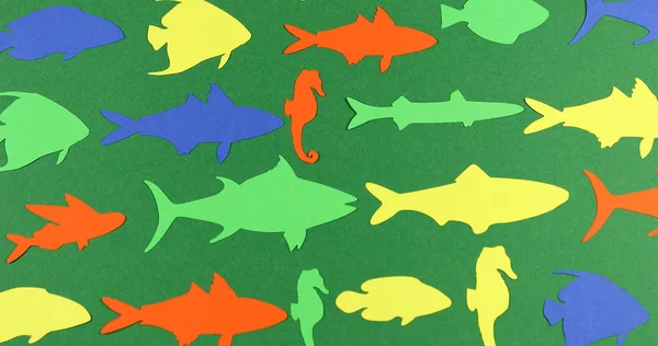 Animated stop motion floating paper colored fish.