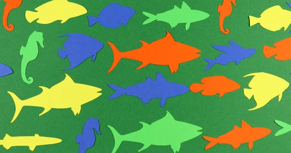 Animated stop motion floating paper colored fish.