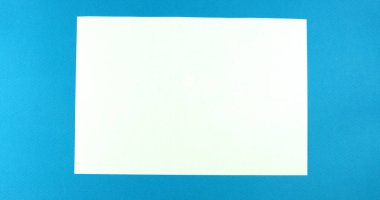 Animated stop motion smoothing a blank sheet on a colored background.