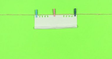 Animated stop motion smoothing a blank sheet on a colored background.
