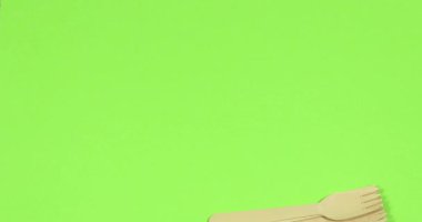 Stop motion Disposable appliance background for a meal of wood. Eco concept.