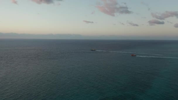 Filmación aérea después de dos barcos hacia el mar al amanecer - Vista lateral — Vídeo de stock