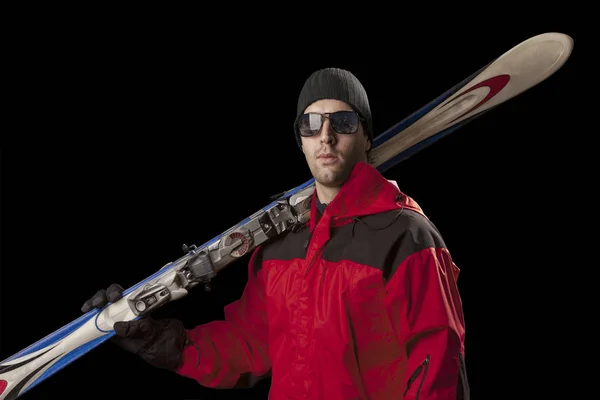 Skier holding a pair of skis — Stock Photo, Image