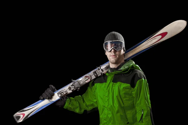 Skier holding a pair of skis — Stock Photo, Image