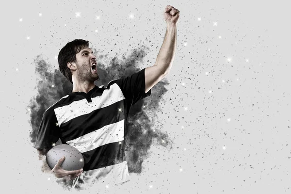 Rugby player coming out of a blast of smoke. — Stock Photo, Image