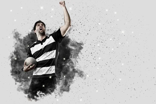 Rugbyspieler kommt aus einer Rauchwolke. — Stockfoto