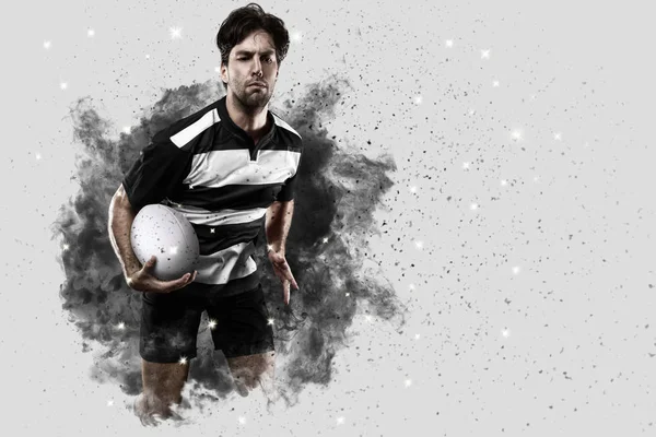 Rugby player coming out of a blast of smoke. — Stock Photo, Image