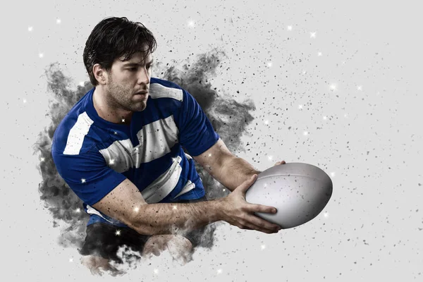 Rugbyspeler coming out van een explosie van rook. — Stockfoto