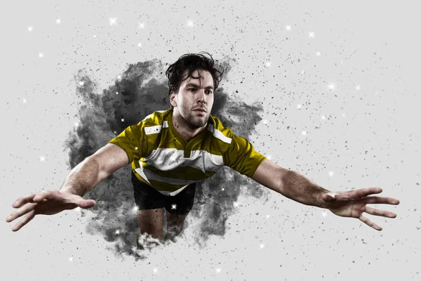 Rugby player coming out of a blast of smoke. — Stock Photo, Image