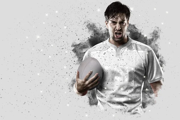 Rugbyspeler coming out van een explosie van rook. — Stockfoto