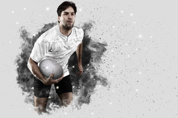 Rugby player coming out of a blast of smoke. — Stock Photo, Image