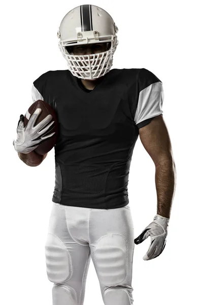 Jogador de futebol com um uniforme preto — Fotografia de Stock
