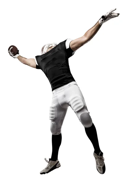 Fotbollsspelare med en svart uniform — Stockfoto