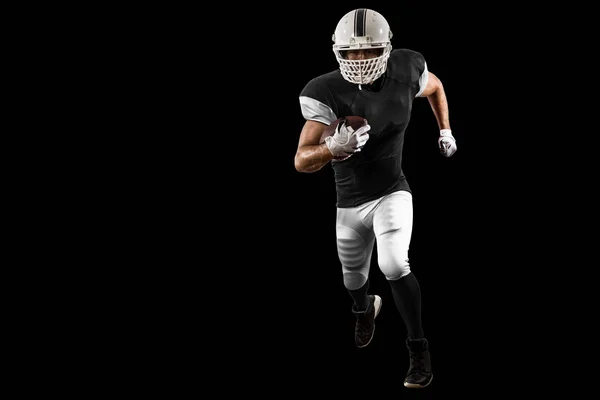 Jogador de futebol com um uniforme preto — Fotografia de Stock