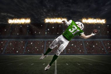 Futbolcu yeşil üniforma ile