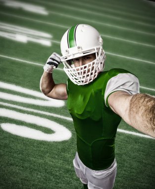 Futbolcu yeşil üniforma ile