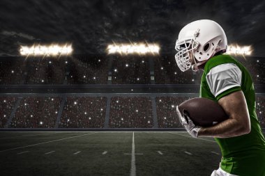 Futbolcu yeşil üniforma ile