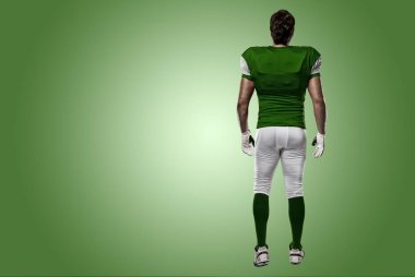Futbolcu yeşil üniforma ile