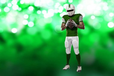 Futbolcu yeşil üniforma ile