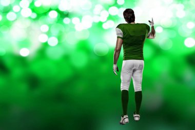 Futbolcu yeşil üniforma ile