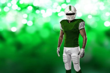 Futbolcu yeşil üniforma ile