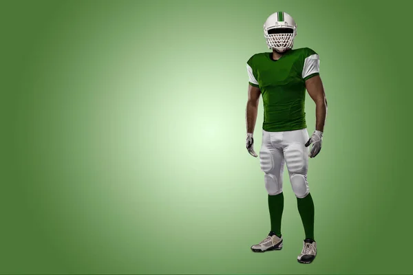 Football Player with a green uniform — Stock Photo, Image